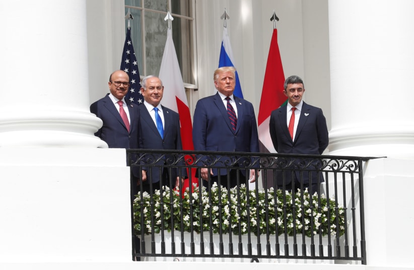 Abdullatif Al Zayani, Benjamin Netanyahu, Donald Trump, and Abdullah bin Zayed sign the Abraham Accords (photo credit: REUTERS/TOM BRENNER)