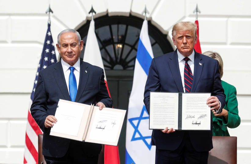 Israel's Prime Minister Benjamin Netanyahu stands with U.S. President Donald Trump after signing the Abraham Accords (photo credit: REUTERS/TOM BRENNER)