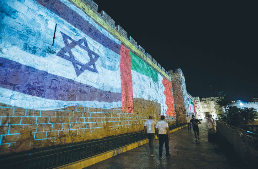 The flags of the United Arab Emirates, Israel and Bahrain are screened on the walls of Jerusalem’s Old City on September 15. (photo credit: YONATAN SINDEL/FLASH90)