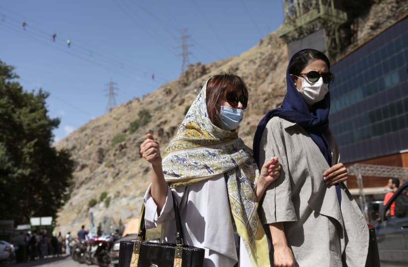 Iranian women wearing protective face masks walk in Darband street, following the outbreak of the coronavirus disease (COVID-19), in Tehran, Iran June 12, 2020 (photo credit: ALI KHARA/WANA (WEST ASIA NEWS AGENCY)/VIA REUTERS)