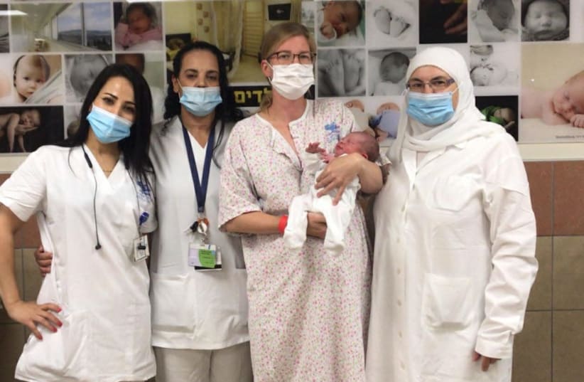 (From right to left): Muna Huaj - a neonatal ward nurse, the mother and Lesta with the baby Avinoam and  midwives Amira Hayeb and Mirabat Sawaed. (photo credit: Courtesy)
