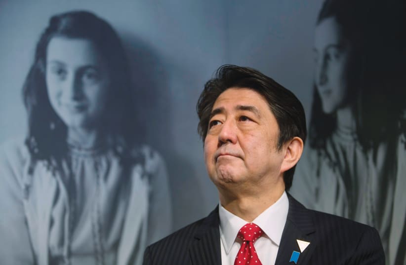 JAPAN’S FORMER prime minister Shinzo Abe visits the Anne Frank House museum in Amsterdam in 2014. (photo credit: REUTERS/CRIS TOALA OLIVARES)