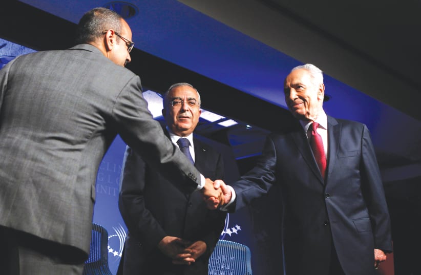 BAHRAIN’S CROWN Prince Salman bin Hamad Al-Khalifa (left) shakes hands with Shimon Peres as former PA prime minister Salam Fayyad looks on, at the Clinton Global Initiative in New York in 2010.  (photo credit: LUCAS JACKSON/REUTERS)