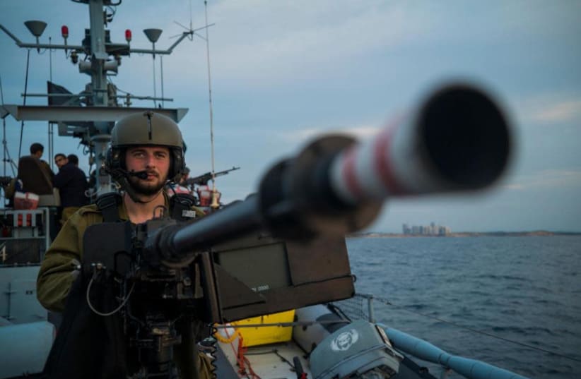 A member of the Navy's 914 Squadron is seen with his gun at the ready. (photo credit: IDF SPOKESPERSON'S UNIT)