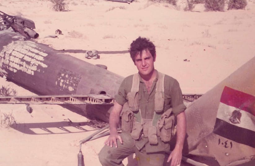 The author next to a downed Egyptian helicopter during the Yom Kippur War. (photo credit: Courtesy)