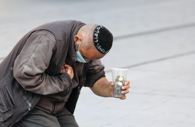 A BEGGAR in Jerusalem. 'People are falling very quickly and they are looking for help anywhere they can find it,’ says Leket’s founder and chairman Joseph Gitler. (photo credit: MARC ISRAEL SELLEM)