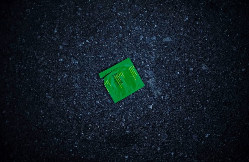 An empty condom wrapper lies on the street in Havana, Cuba, August 27, 2018. (photo credit: REUTERS)