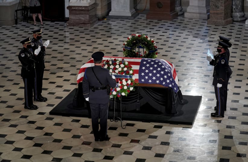 A U.S. Capitol Police honor guard salutes as U.S. Supreme Court Associate Justice Ruth Bader Ginsburg's flag-draped casket lies in state in Statuary Hall at the Capitol, Washington, U.S., September 25, 2020 (photo credit: GREG NASH/POOL VIA REUTERS)