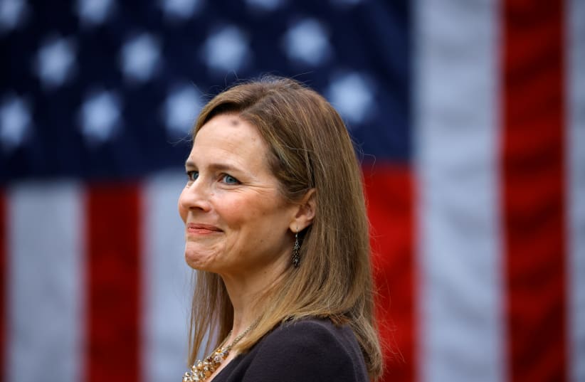 US Court of Appeals for the Seventh Circuit Judge Amy Coney Barrett reacts as US President Donald Trump holds an event to announce her as his nominee to fill the Supreme Court seat left vacant by the death of Justice Ruth Bader Ginsburg. September 26, 2020.  (photo credit: CARLOS BARRIA / REUTERS)
