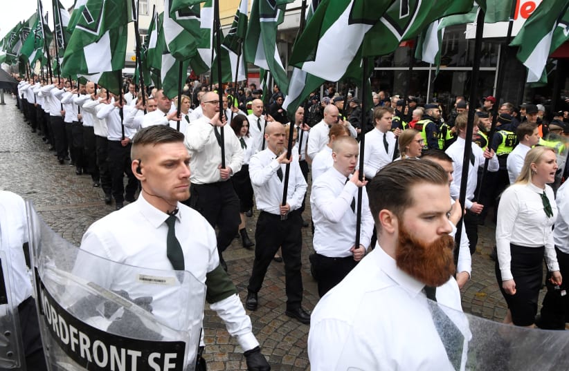 Members of the Neo-nazi Nordic Resistance Movement march through the town of Ludvika, 2018 (photo credit: ULF PALM/TT NEWS AGENCY/VIA REUTERS)