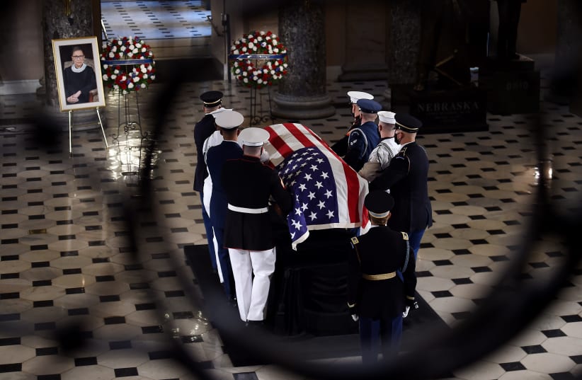The flag-draped casket of the late Supreme Court Justice Ruth Bader Ginsburg leaves the Statuary Hall of the U.S. Capitol, Sept. 25, 2020.  (photo credit: OLIVIER DOULIERY-POOL/GETTY IMAGES)