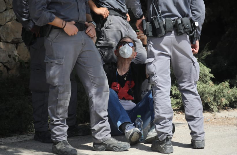 Israeli police officers detain a demonstrator during a protest against Israeli prime minister Benjamin Netanyahu, outside the Israeli parliament in Jerusalem on September 29, 2020. (photo credit: OLIVIER FITOUSSI/FLASH90)