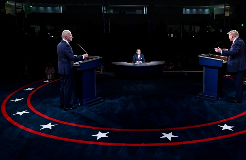 U.S. President Donald Trump and Democratic presidential nominee Joe Biden participate in the first 2020 presidential campaign debate held on the campus of the Cleveland Clinic at Case Western Reserve University in Cleveland, Ohio, U.S., September 29, 2020 (photo credit: OLIVIER DOULIERY/POOL VIA REUTERS)