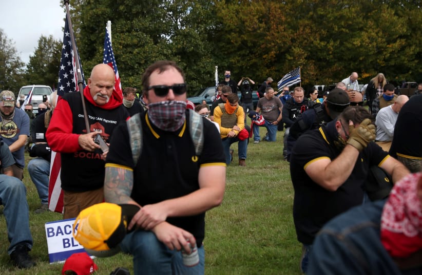 Supporters of the far right group Proud Boys pray as they attend a rally in Portland, Oregon, U.S., September 26, 2020. (photo credit: REUTERS/LEAH MILLIS)