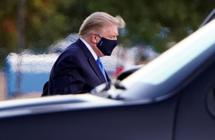 U.S. President Donald Trump arrives at Walter Reed National Military Medical Center by helicopter after the White House announced that he "will be working from the presidential offices at Walter Reed for the next few days" after testing positive for the coronavirus disease (COVID-19), in Bethesda, M (photo credit: REUTERS/JOSHUA ROBERTS/FILE PHOTO)