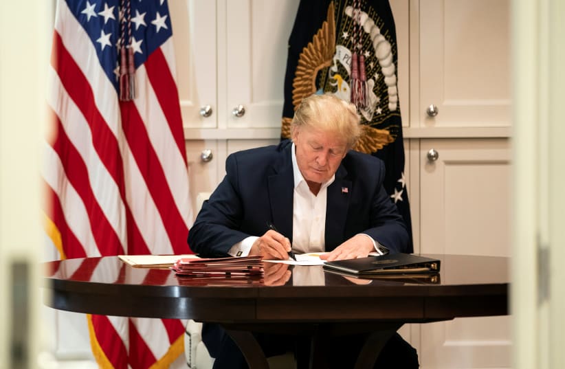 U.S. President Donald Trump works in the Presidential Suite while receiving treatment after testing positive for the coronavirus disease (COVID-19) at Walter Reed National Military Medical Center in Bethesda, Maryland, U.S. October 3, 2020 (photo credit: JOYCE N. BOGHOSIA/THE WHITE HOUSE/HANDOUT VIA REUTERS)