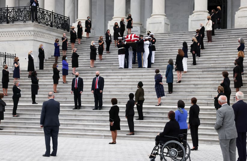Female legislators look on as the casket of Supreme Court Associate Justice Ruth Bader Ginsburg is carried following ceremonies honoring her at the US Capitol in Washington on September 25 (photo credit: JONATHAN ERNST / REUTERS)
