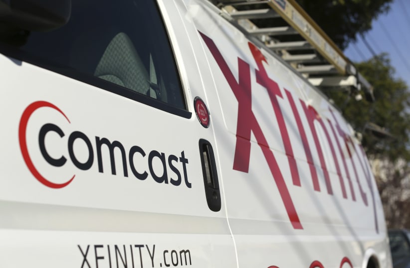 A Comcast sign is shown on the side of a vehicle in San Francisco (photo credit: ROBERT GALBRAITH/REUTERS)