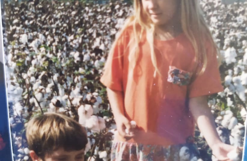 ALLYSON GAIL SPENCER at age 7 with Aaron in the cotton fields of North Carolina.  (photo credit: BRACHA CRAMER)
