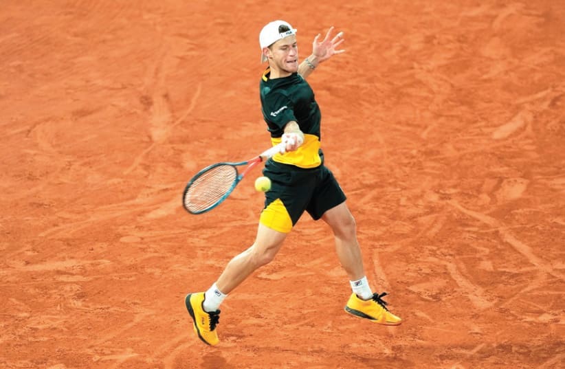 DIEGO SCHWARTZMAN returns a shot to Dominic Thiem in the fourth set of his 7-6(1), 5-7, 6-7(6), 7-6(5), 6-2 victory at the French Open late Tuesday night. (photo credit: REUTERS)