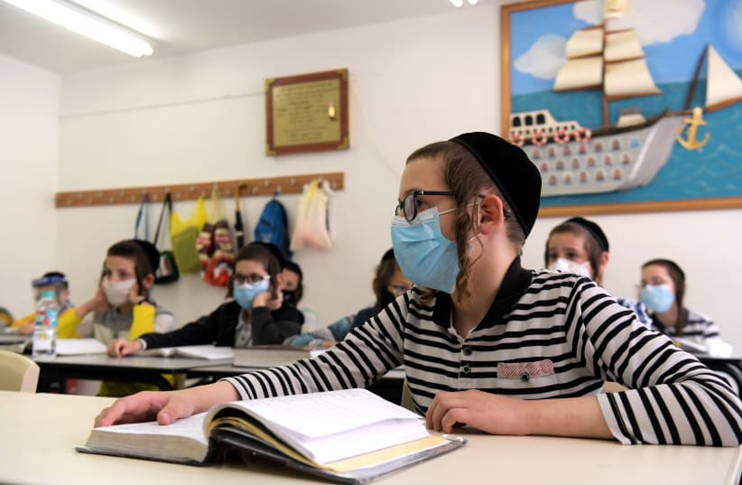 Ultra-Orthodox children wearing face masks at their school in the city of Rehovot, May 24, 2020 (photo credit: YOSSI ZELIGER/FLASH90)