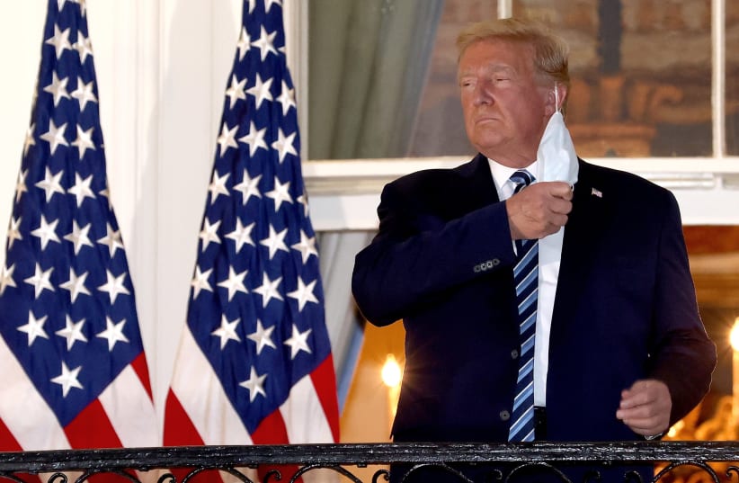 US PRESIDENT Donald Trump removes his mask upon return to the White House on Monday from Walter Reed National Military Medical Center, where he spent three days hospitalized for coronavirus.  (photo credit: WIN MCNAMEE/GETTY IMAGES/TNS)