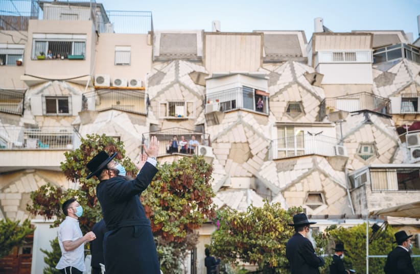 MEN PRAY outside the Ramot Polin Apartments in Jerusalem’s Ramot neighborhood last month.  (photo credit: YONATAN SINDEL/FLASH90)