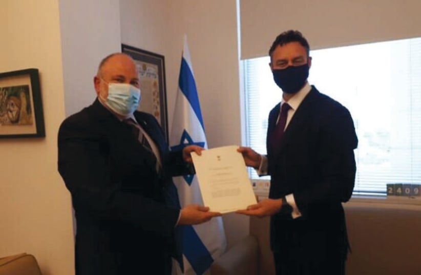 AUSTRALIA’S NEW ambassador to Israel, Paul Griffiths (right), presents his credentials to the Foreign Ministry’s Chief of Protocol Meron Reuben, October, 2020. (photo credit: PROTOCOL DEPT. MFA))