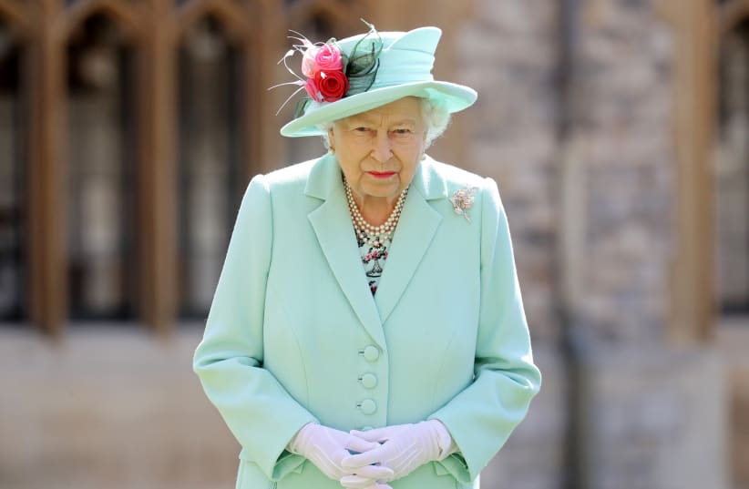 Britain's Queen Elizabeth poses after awarding Captain Tom Moore with the insignia of Knight Bachelor at Windsor Castle, in Windsor, Britain July 17, 2020. (photo credit: REUTERS/CHRIS JACKSON)