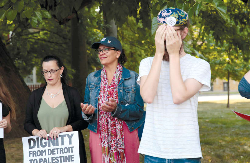 CONGRESSWOMAN RASHIDA TLAIB (center) takes part in a ’Shabbat in The Park’ hosted by Jewish Voice for Peace Action in Detroit, last year.  (photo credit: REBECCA COOK / REUTERS)