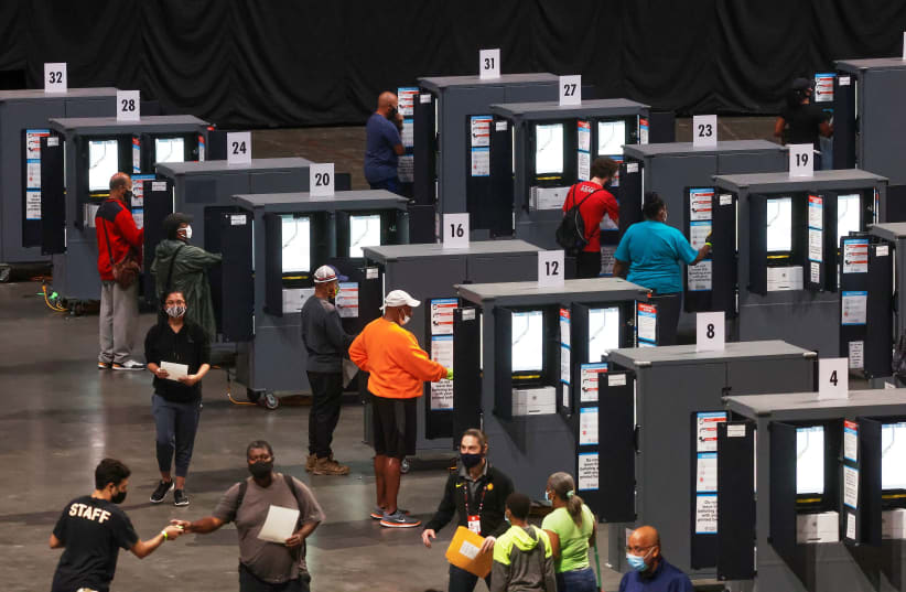 People cast their ballots during early voting for the upcoming presidential elections inside of The Atlanta Hawks' State Farm Arena in Atlanta, Georgia, US, October 12, 2020 (photo credit: CHRIS ALUKA BERRY/ REUTERS)
