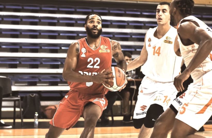 HAPOEL JERUSALEM guard Tarik Philip drives to the hoop during the Reds’ 103-96 overtime victory of Maccabi Rishon Lezion in Balkan League action (photo credit: DOV HALICKMAN PHOTOGRAPHY)