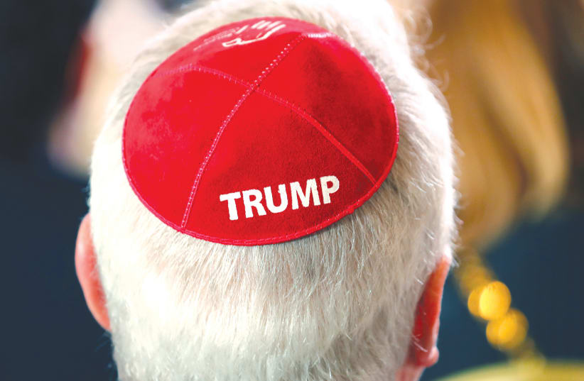 A MAN wears a Trump kippah while waiting for Trump to address the Republican Jewish Coalition 2019 Annual Leadership Meeting in Las Vegas. (photo credit: KEVIN LAMARQUE/REUTERS)