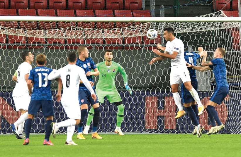 ISRAEL STRIKER Eran Zahavi heads home the blue-and-white’s first goal early in the second half of its 3-2 comeback victory over host Slovakia in Nations League action. (photo credit: REUTERS)