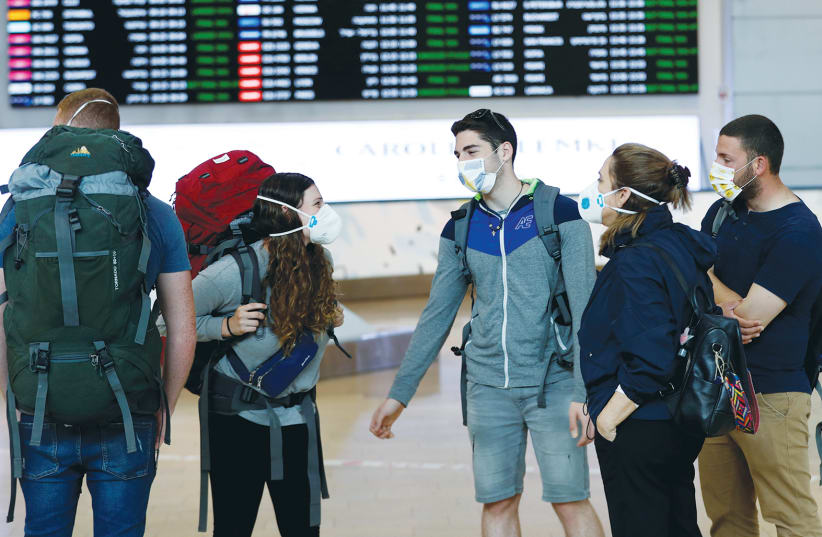 Travelers at Ben-Gurion Airport in March - to bring tourists back to Israel is not an act of lunacy. (photo credit: RONEN ZVULUN / REUTERS)