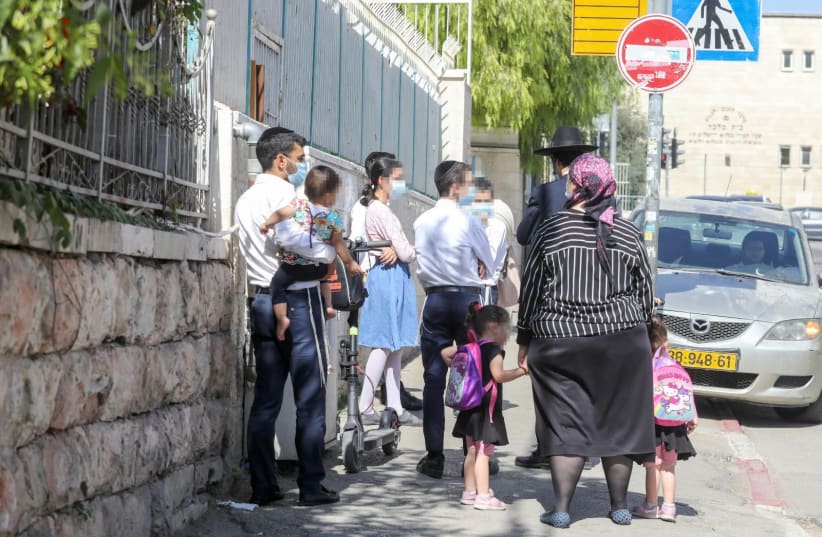 A haredi family walks down the street in the Makor Baruch neighborhood of Jerusalem (photo credit: MARC ISRAEL SELLEM)