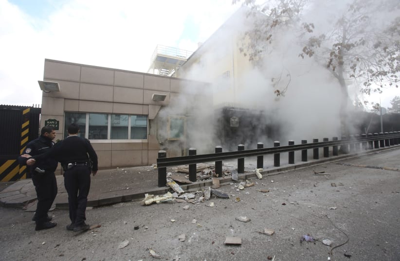 Turkish police officers react after an explosion at the entrance of the U.S. Embassy in Ankara February 1, 2013 (photo credit: REUTERS)