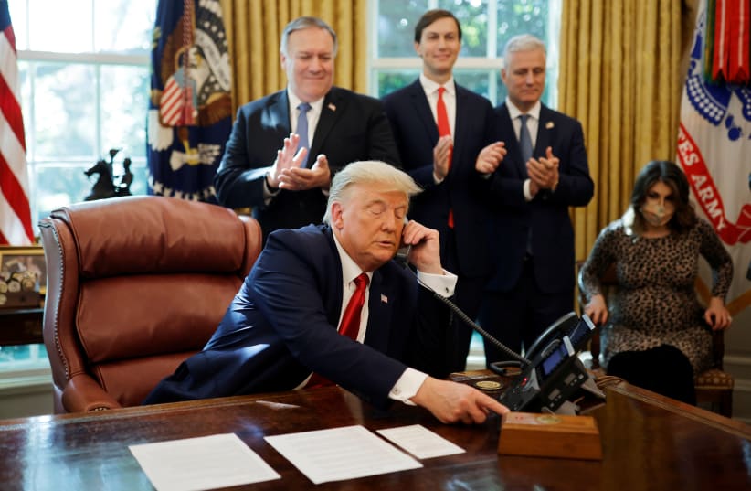 U.S. President Donald Trump is seen on the phone with leaders of Israel and Sudan. (photo credit: REUTERS/CARLOS BARRIA)