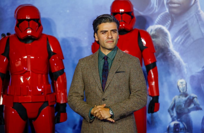 Cast member Oscar Isaac poses as he attends the premiere of "Star Wars: The Rise of Skywalker" in London, Britain (photo credit: REUTERS/HENRY NICHOLLS)