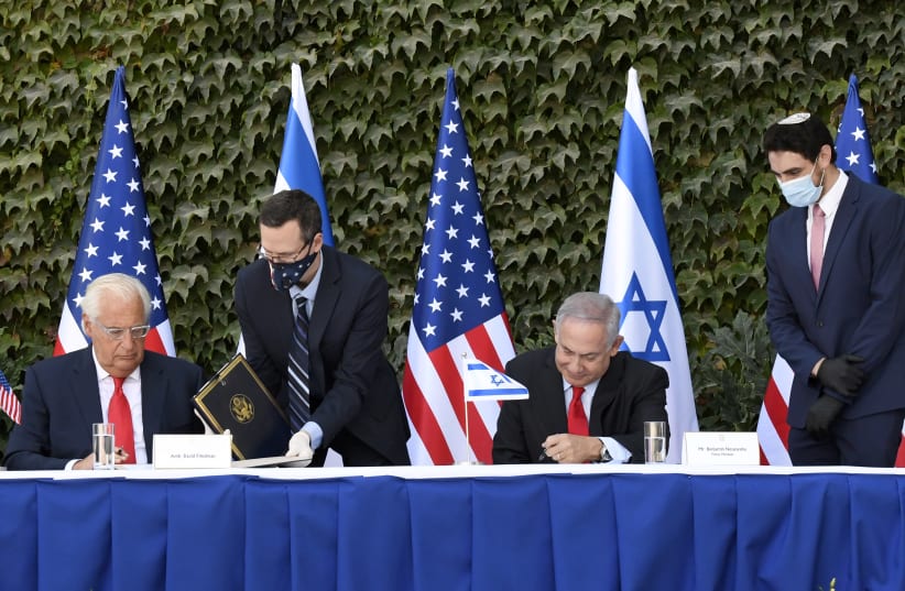  U.S Ambassador to Israel David M. Friedman and Israeli Prime Minister Benjamin Netanyahu sign agreements to further binational scientific and technological cooperation in a special ceremony held at Ariel University on October 28, 2020. (photo credit: MATTY STERN / US EMBASSY JERUSALEM)