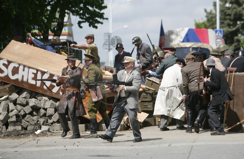 Actors in Prague dressed as resistance fighters reenact the uprising in May 1945. (photo credit: DAVID W. CERNY / REUTERS)