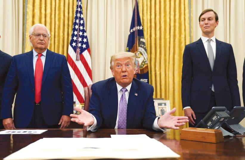 US AMBASSADOR to Israel David Friedman and White House senior adviser Jared Kushner stand behind US President Donald Trump in the Oval Office in August. (photo credit: KEVIN LAMARQUE/REUTERS)