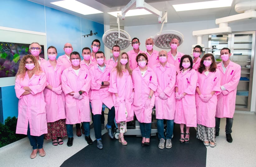 Doctors and specialists in plastic surgery from public hospitals involved in breast reconstruction gathered for a joint photo in pink robes. (photo credit: ISRAEL HADARI)
