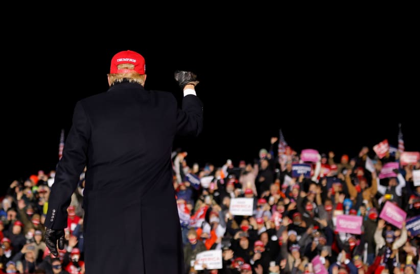 US President Donald Trump holds a campaign rally at Gerald R. Ford International Airport in Grand Rapids, Michigan (photo credit: CARLOS BARRIA / REUTERS)