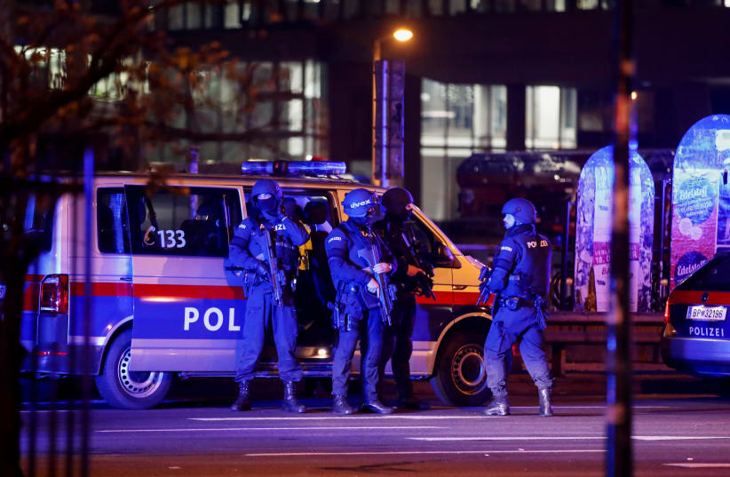 Police officers stand guard on a street after exchanges of gunfire in Vienna, Austria November 3, 2020 (photo credit: LEONHARD FOEGER / REUTERS)