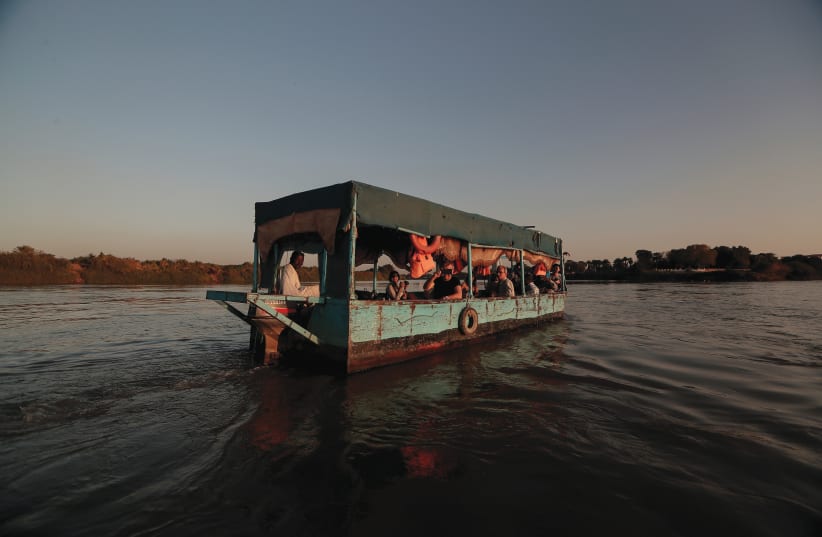 TOURISTS SAIL across the convergence between the White Nile river and Blue Nile river in Khartoum, Sudan, on February 15.  (photo credit: ZOHRA BENSEMRA/REUTERS)