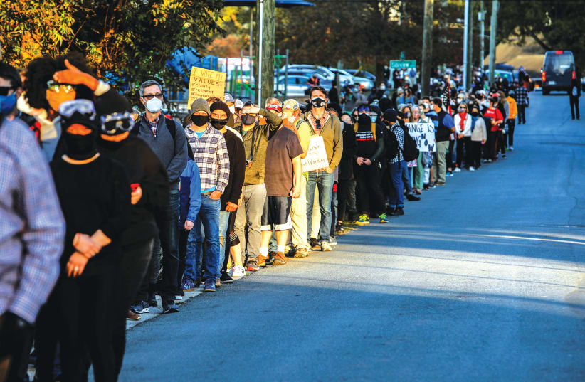 DEMONSTRATORS MARCH for voting rights on Election Day, Tuesday, in Graham, North Carolina. (photo credit: JONATHAN DRAKE / REUTERS)