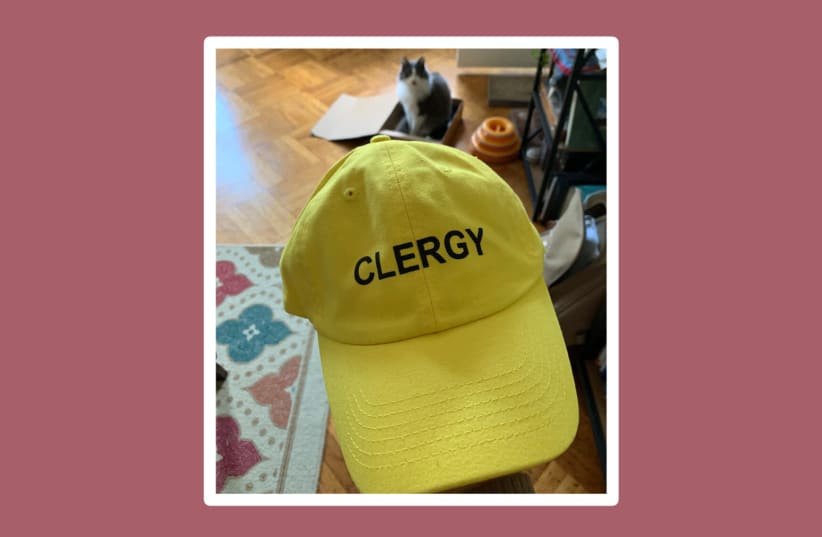 Rabbi Emily Cohen has a yellow hat emblazoned with the word "clergy" ready to wear to protests, where she plans to help deescalate possible violent situations. (photo credit: COURTESY OF RABBI EMILY COHEN)