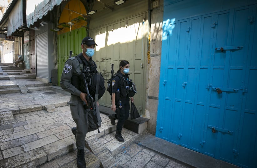 Israeli Police patrol as they reinforce Covid-19 restriction in the Old City of Jerusalem during a nationwide lockdown to prevent the spread of COVID-19. October 12, 2020. (photo credit: OLIVIER FITOUSSI/FLASH90)