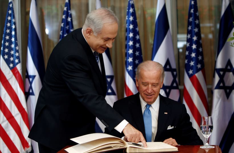 U.S. Vice President Joe Biden (R) prepares to sign the guest book before his meeting with Israel's Prime Minister Benjamin Netanyahu at Netanyahu's residence in Jerusalem March 9, 2010. (photo credit: REUTERS/Ronen Zvulun)